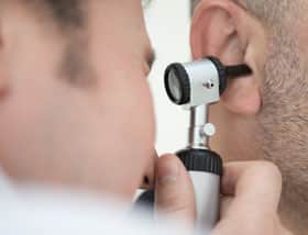 Audiologist giving a hearing exam