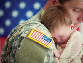 Soldier hugging his son with Tinnitus